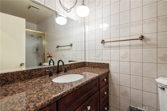 13150 Stern Ave, La Mirada, CA 90638 - full bathroom with tile walls, vanity, an enclosed shower, and toilet