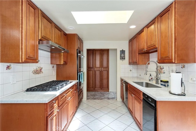 13150 Stern Ave, La Mirada, CA 90638 - kitchen with a sink, under cabinet range hood, appliances with stainless steel finishes, a skylight, and backsplash