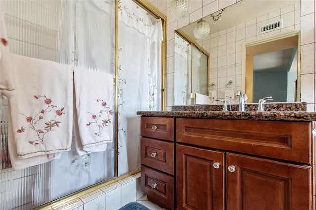 13150 Stern Ave, La Mirada, CA 90638 - bathroom featuring vanity and tile walls