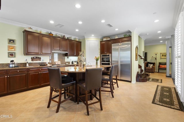 4003 Galapagos Way, Oxnard, CA 93035 - kitchen featuring stainless steel appliances, crown molding, a breakfast bar area, a kitchen island with sink, and light tile patterned floors
