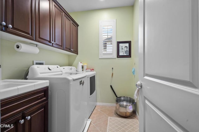 4003 Galapagos Way, Oxnard, CA 93035 - laundry area featuring cabinet space, washer and clothes dryer, light tile patterned floors, and baseboards