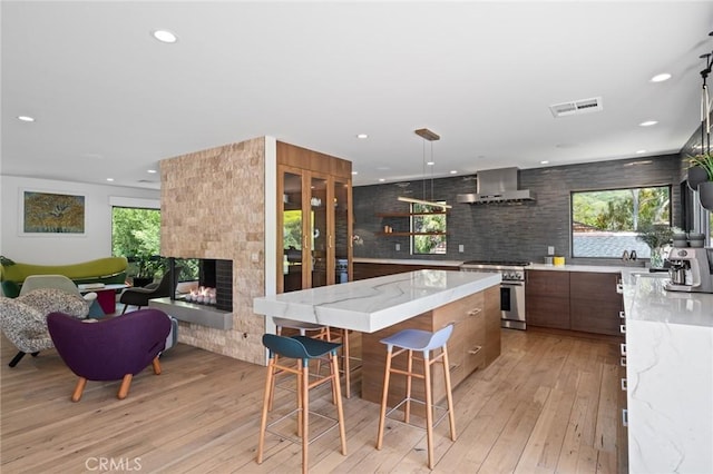 1435 Cerritos Dr, Laguna Beach, CA 92651 - kitchen featuring high end range, wall chimney range hood, modern cabinets, light wood-style flooring, and recessed lighting