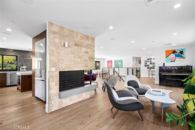1435 Cerritos Dr, Laguna Beach, CA 92651 - living area with light wood finished floors, recessed lighting, and a stone fireplace