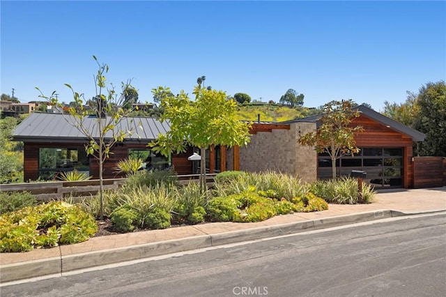 1435 Cerritos Dr, Laguna Beach, CA 92651 - view of front of property featuring a standing seam roof, a garage, driveway, and metal roof