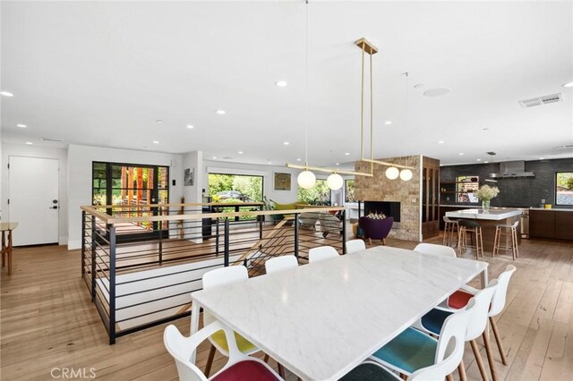1435 Cerritos Dr, Laguna Beach, CA 92651 - dining room featuring light wood finished floors, recessed lighting, and a fireplace