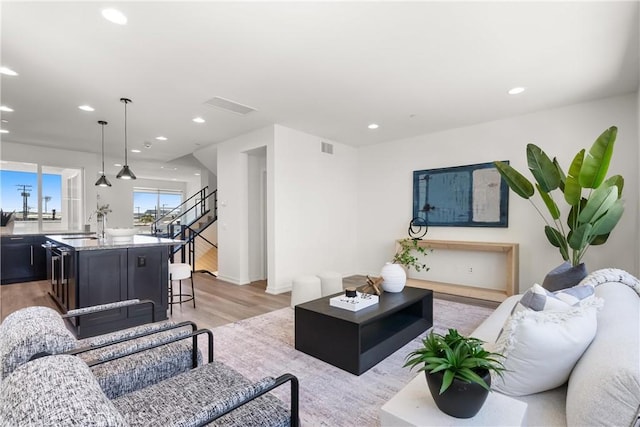 645 Channel Way, Costa Mesa, CA 92627 - living room featuring light wood-type flooring, recessed lighting, baseboards, and stairway