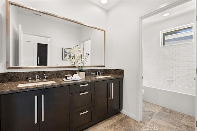 645 Channel Way, Costa Mesa, CA 92627 - bathroom featuring double vanity, toilet, baseboards, shower / bath combination, and stone tile flooring