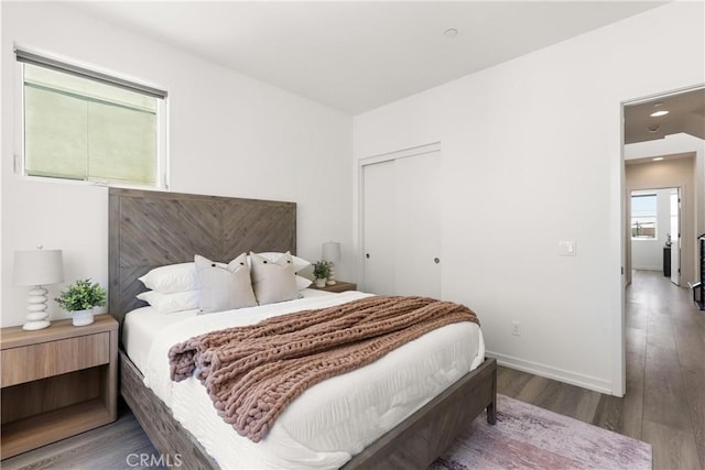 645 Channel Way, Costa Mesa, CA 92627 - bedroom with wood finished floors, a closet, and baseboards