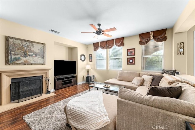 35509 Trevino Trl, Beaumont, CA 92223 - living area featuring ceiling fan, dark wood-style flooring, a fireplace with raised hearth, and baseboards
