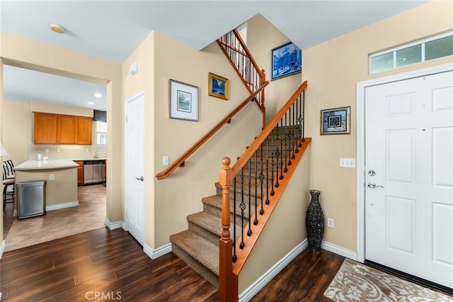 35509 Trevino Trl, Beaumont, CA 92223 - foyer entrance featuring dark wood finished floors, stairway, and baseboards
