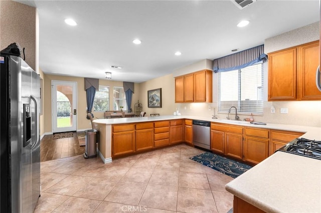 35509 Trevino Trl, Beaumont, CA 92223 - kitchen featuring appliances with stainless steel finishes, a sink, a peninsula, recessed lighting, and light countertops