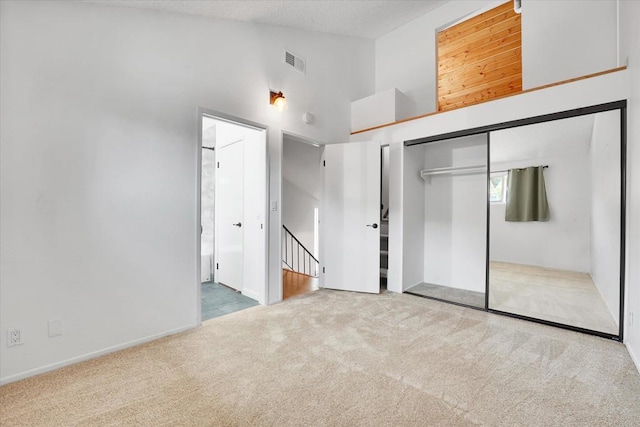 7077 Camino Pacheco, San Diego, CA 92111 - unfurnished bedroom with carpet floors, high vaulted ceiling, a closet, connected bathroom, and baseboards