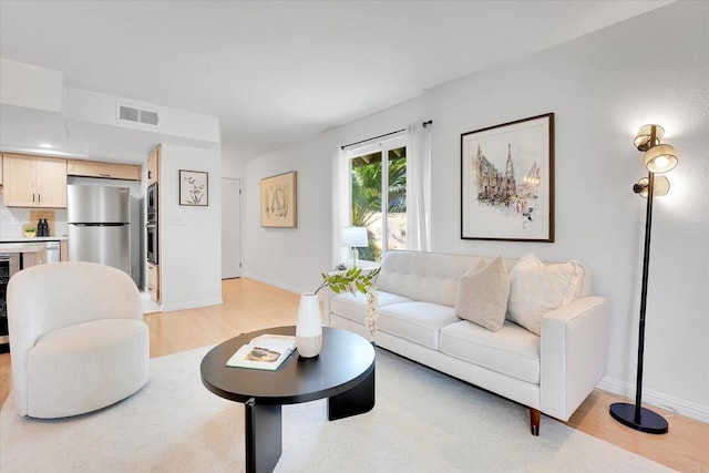 7077 Camino Pacheco, San Diego, CA 92111 - living area featuring light wood-style flooring and baseboards