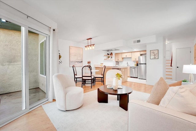 7077 Camino Pacheco, San Diego, CA 92111 - living room featuring light wood-style floors and stairway
