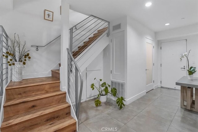 11023 Fruitland Dr Unit 104, Studio City, CA 91604 - foyer with stairs, recessed lighting, baseboards, and light tile patterned flooring