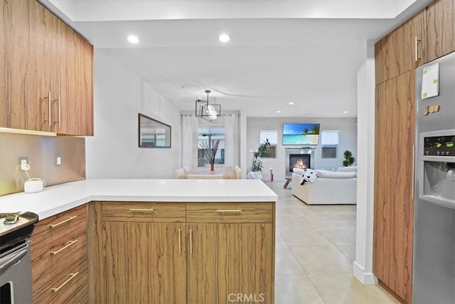 11023 Fruitland Dr Unit 104, Studio City, CA 91604 - kitchen featuring appliances with stainless steel finishes, a peninsula, light tile patterned flooring, light countertops, and recessed lighting