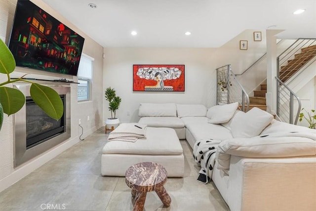11023 Fruitland Dr Unit 104, Studio City, CA 91604 - living room with stairs, recessed lighting, a glass covered fireplace, baseboards, and concrete floors