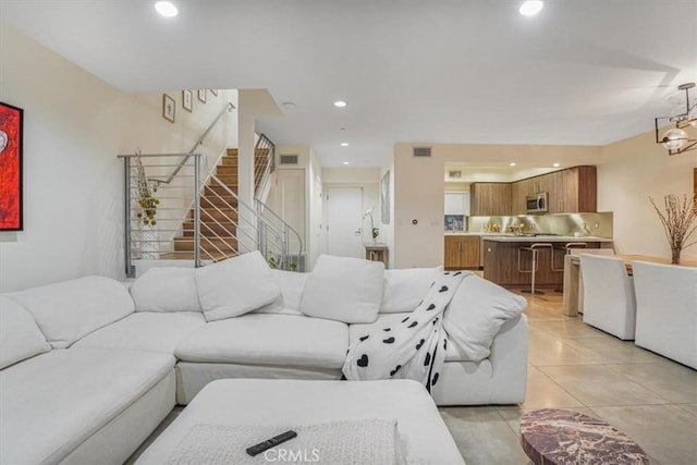 11023 Fruitland Dr Unit 104, Studio City, CA 91604 - living room featuring light tile patterned flooring, stairway, and recessed lighting