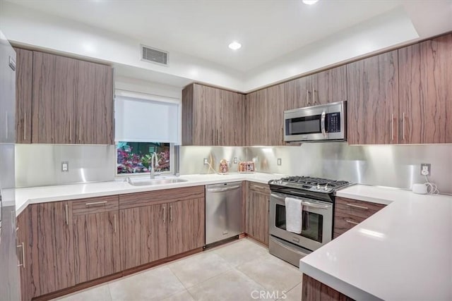 11023 Fruitland Dr Unit 104, Studio City, CA 91604 - kitchen featuring stainless steel appliances, a sink, light countertops, and light tile patterned floors