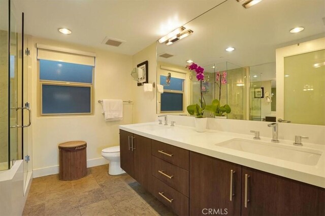 11023 Fruitland Dr Unit 104, Studio City, CA 91604 - bathroom with a shower with door, double vanity, toilet, baseboards, and a tub