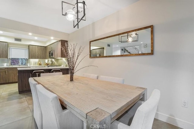 11023 Fruitland Dr Unit 104, Studio City, CA 91604 - dining space featuring a chandelier, baseboards, and recessed lighting