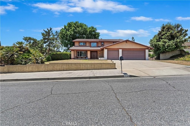 6164 Amberwood Dr, Rancho Cucamonga, CA 91701 - view of front of home with an attached garage, concrete driveway, and stucco siding