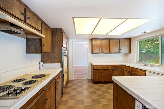 6164 Amberwood Dr, Rancho Cucamonga, CA 91701 - kitchen featuring tile counters, a sink, white appliances, and brown cabinetry