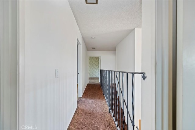 6164 Amberwood Dr, Rancho Cucamonga, CA 91701 - corridor with dark colored carpet, an upstairs landing, a textured ceiling, and baseboards