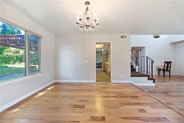 6164 Amberwood Dr, Rancho Cucamonga, CA 91701 - unfurnished dining area with stairway, light wood-style flooring, a chandelier, and baseboards