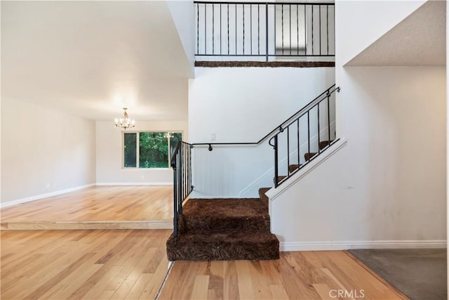 6164 Amberwood Dr, Rancho Cucamonga, CA 91701 - stairway with wood finished floors, a chandelier, and baseboards