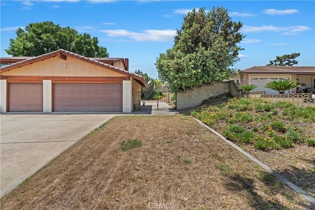 6164 Amberwood Dr, Rancho Cucamonga, CA 91701 - view of front facade featuring a gate, concrete driveway, a garage, stucco siding, and a tile roof