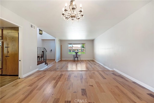 6164 Amberwood Dr, Rancho Cucamonga, CA 91701 - unfurnished living room featuring a chandelier, light wood finished floors, stairs, and baseboards