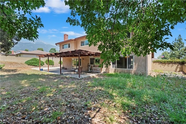 6164 Amberwood Dr, Rancho Cucamonga, CA 91701 - back of property featuring stucco siding, a chimney, a pergola, and a patio area