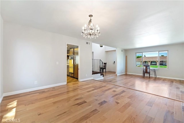 6164 Amberwood Dr, Rancho Cucamonga, CA 91701 - unfurnished living room featuring light wood-style floors, stairs, a chandelier, and baseboards