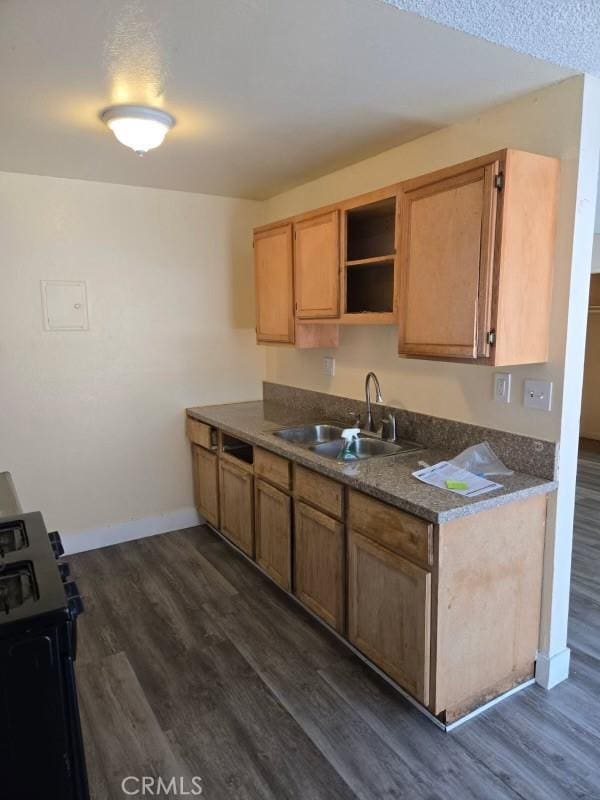 14805 Chase St Unit 107, Panorama City, CA 91402 - kitchen with a sink, gas range, dark wood-style floors, baseboards, and open shelves