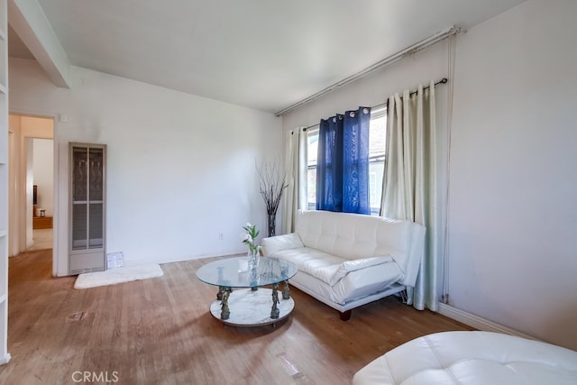 327 S 35th St, San Diego, CA 92113 - living area featuring wood finished floors, a heating unit, and baseboards