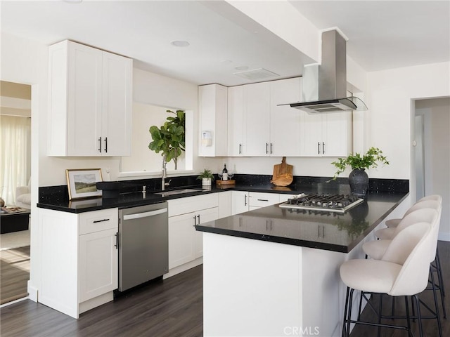 5512 W 117th St, Hawthorne, CA 90304 - kitchen featuring stainless steel appliances, range hood, dark wood-type flooring, and a peninsula
