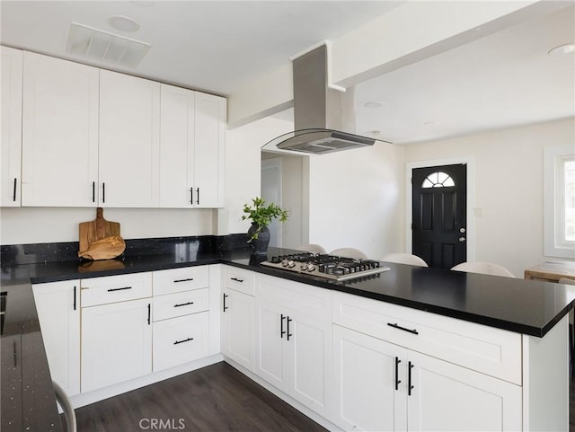 5512 W 117th St, Hawthorne, CA 90304 - kitchen featuring island exhaust hood, stainless steel gas cooktop, a peninsula, dark wood-style flooring, and dark countertops