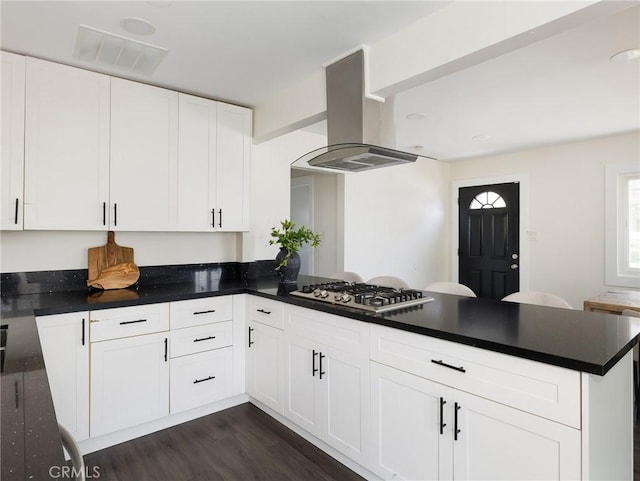 5512 W 117th St, Hawthorne, CA 90304 - kitchen with island range hood, stainless steel gas stovetop, a peninsula, dark wood finished floors, and dark countertops