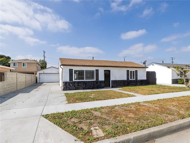 5512 W 117th St, Hawthorne, CA 90304 - view of front facade with stone siding, a detached garage, stucco siding, and an outbuilding
