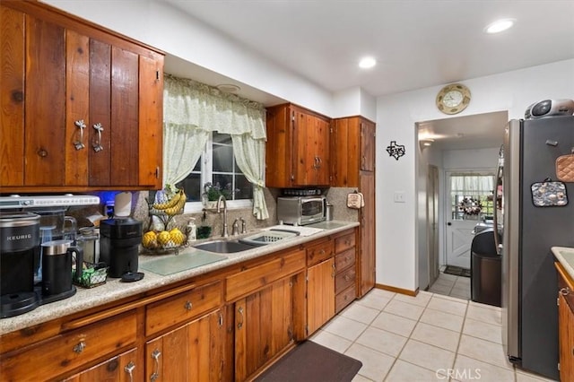 6096 Crawford St, San Diego, CA 92120 - kitchen with freestanding refrigerator, a sink, light tile patterned flooring, light countertops, and backsplash