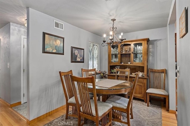 6096 Crawford St, San Diego, CA 92120 - dining area featuring light wood-style floors, a chandelier, and baseboards
