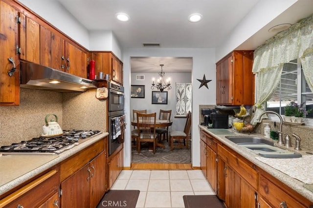 6096 Crawford St, San Diego, CA 92120 - kitchen featuring under cabinet range hood, a sink, stainless steel gas cooktop, tasteful backsplash, and light countertops