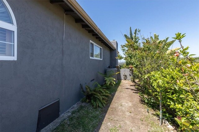 6096 Crawford St, San Diego, CA 92120 - view of side of home with stucco siding and central AC