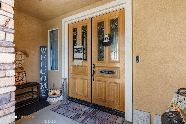 11703 Revolution Rd, Bakersfield, CA 93312 - doorway to property featuring stucco siding and a porch
