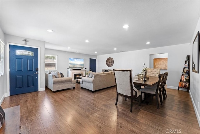 114 N Orange Ave, Fullerton, CA 92833 - dining room featuring dark wood-style flooring, recessed lighting, baseboards, and a warm lit fireplace