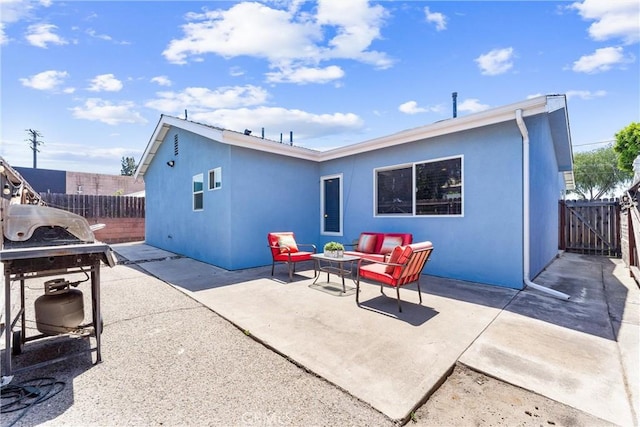 114 N Orange Ave, Fullerton, CA 92833 - rear view of property featuring an outdoor hangout area, a fenced backyard, a patio area, stucco siding, and a gate