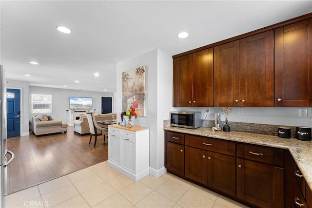 114 N Orange Ave, Fullerton, CA 92833 - kitchen featuring stainless steel microwave, recessed lighting, light stone counters, open floor plan, and baseboards