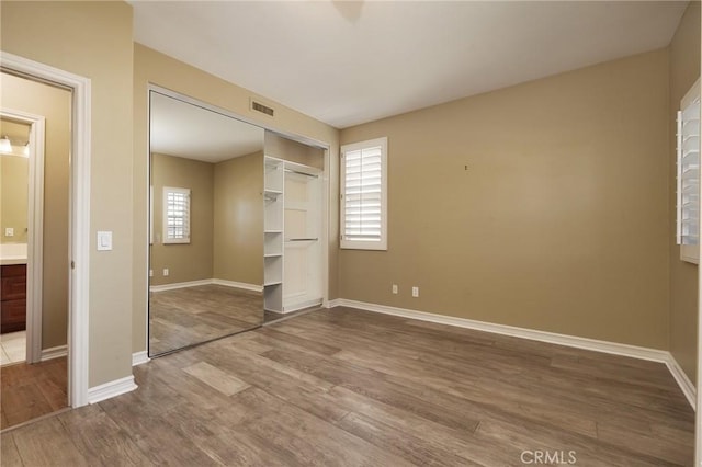 6471 Frampton Cir, Huntington Beach, CA 92648 - unfurnished bedroom featuring wood finished floors and a closet