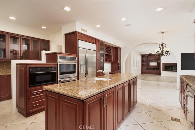 6471 Frampton Cir, Huntington Beach, CA 92648 - kitchen with stainless steel appliances, a chandelier, light tile patterned floors, hanging light fixtures, and recessed lighting